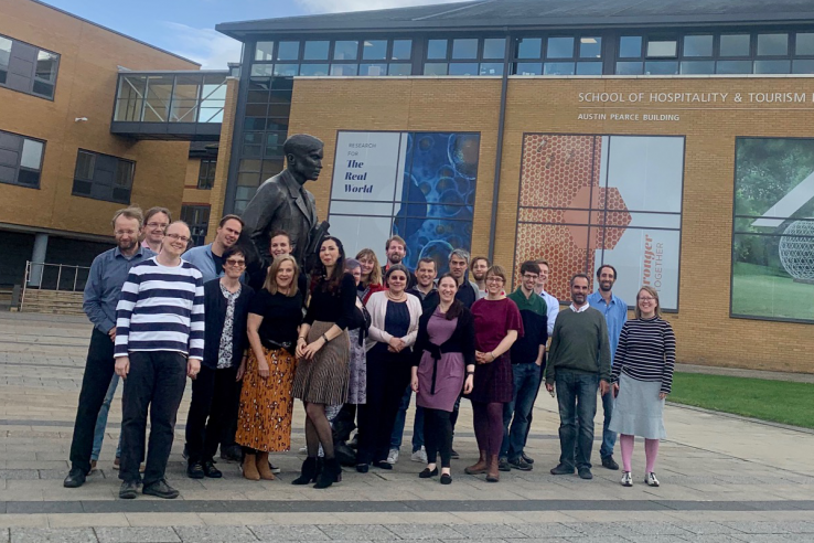 The members of the MeMad consortium posing in front of the University of Surrey