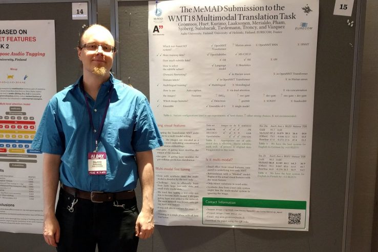 wp4-wmt-poster A conference presenter standing by his research poster representing MeMAD.